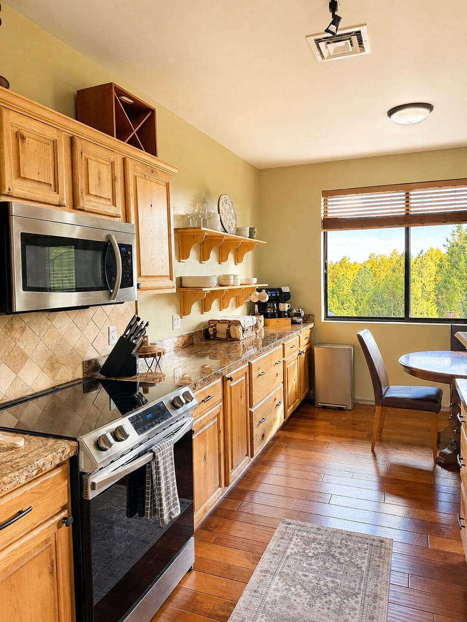 Full kitchen with granite counters, dining nook, and scenic window views