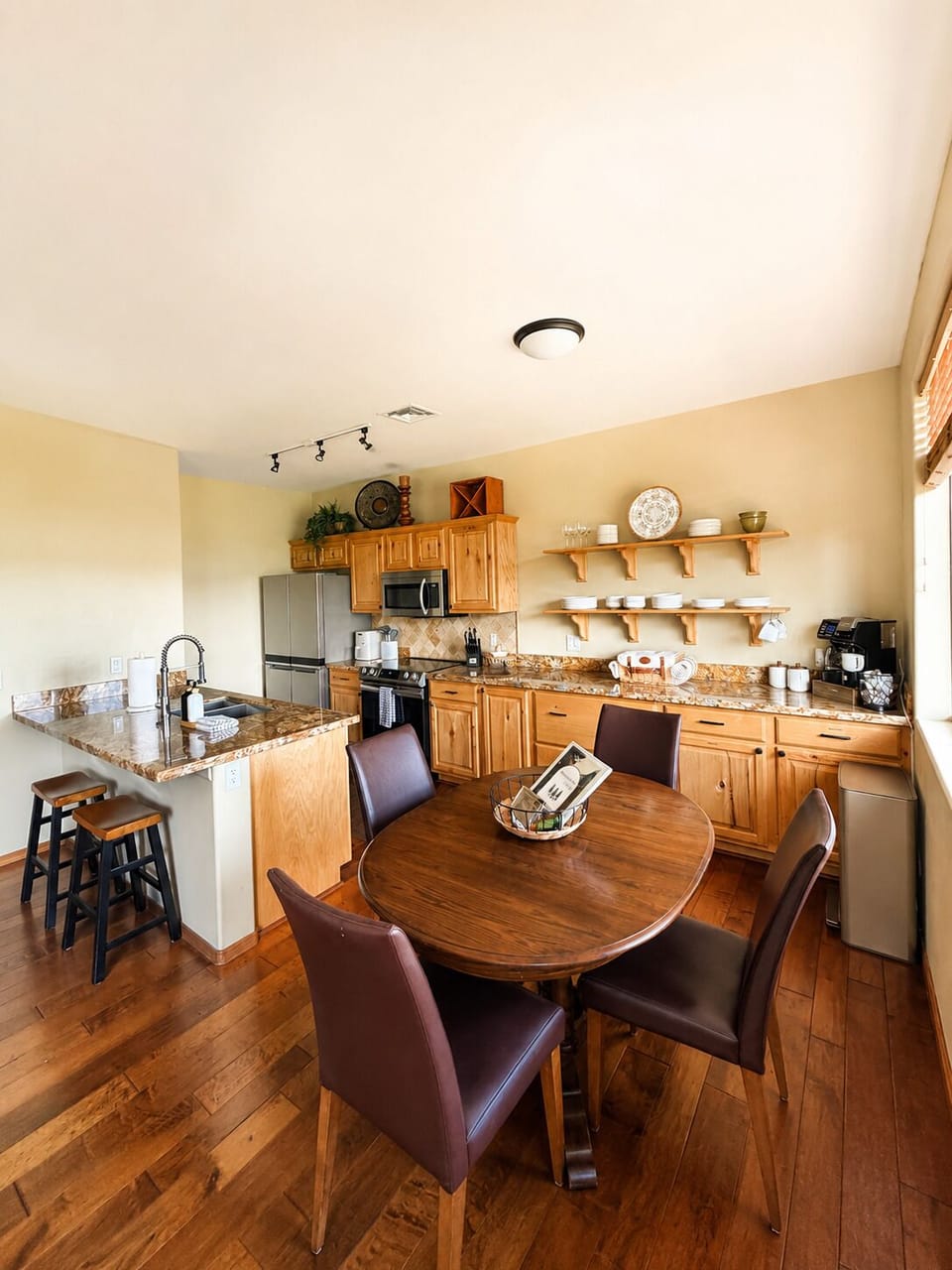 Full kitchen with dining for 4, breakfast bar, and granite counters