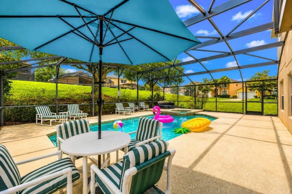 Shaded patio dining area by the pool — ideal for outdoor meals & lazy afternoons.