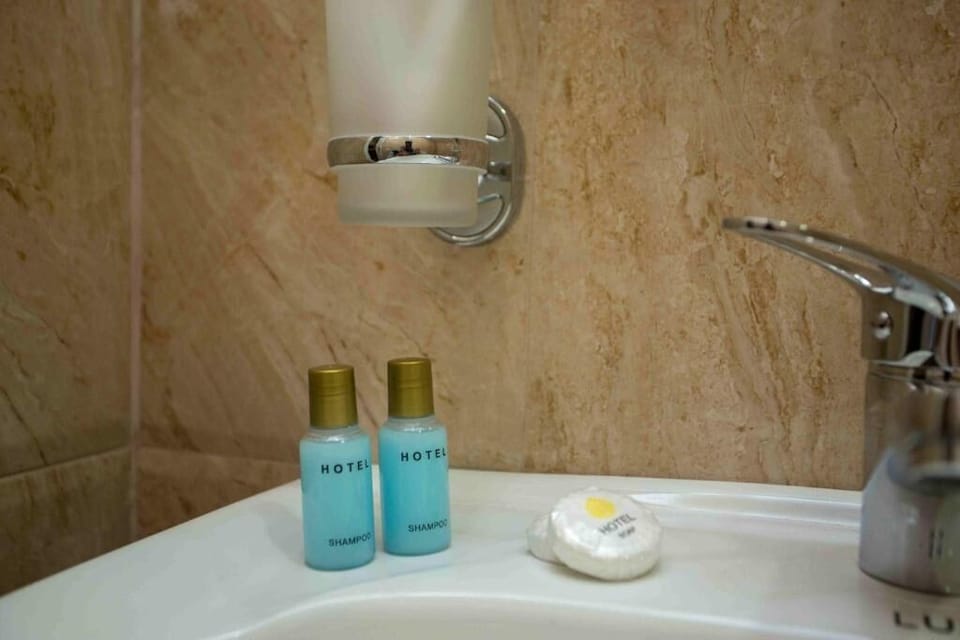 Shower, hair dryer, slippers, towels