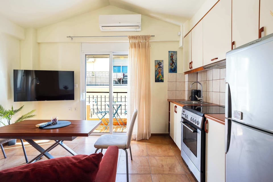 Functional studio space with kitchenette and balcony views