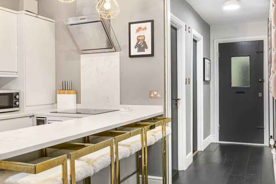Modern kitchen entry with bar seating and a clean, polished look