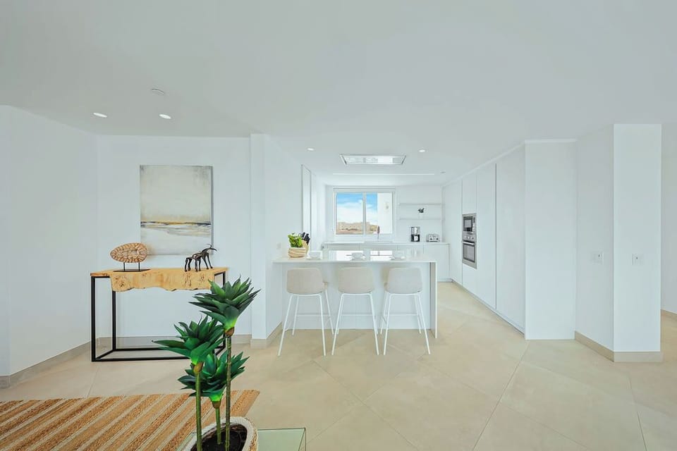 Step into this bright, airy kitchen where clean lines and coastal views invite you to start your day in style.