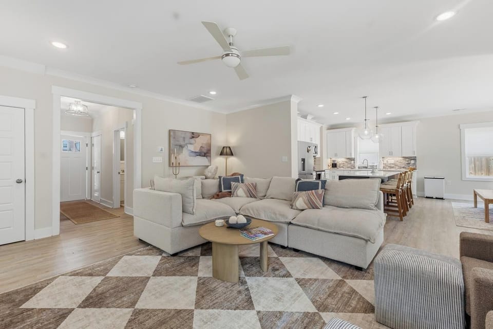 Relax in your open-concept living space with plush seating, stylish décor, and seamless flow to a bright, modern kitchen—perfect for unwinding or gathering together.