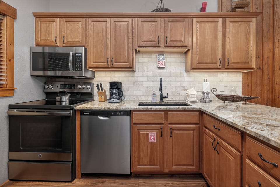 Your fully equipped kitchen features granite countertops, stainless steel appliances, and all the essentials for preparing your favorite meals during your mountain getaway.
