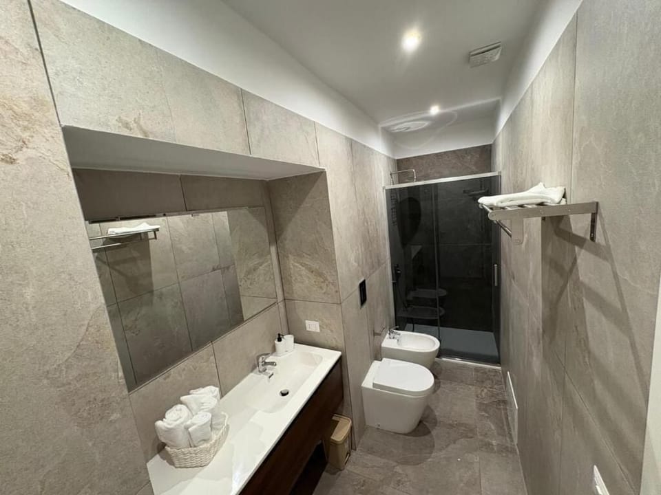 Basic Double Room, Balcony, City View | Bathroom | Shower, hair dryer, slippers, towels