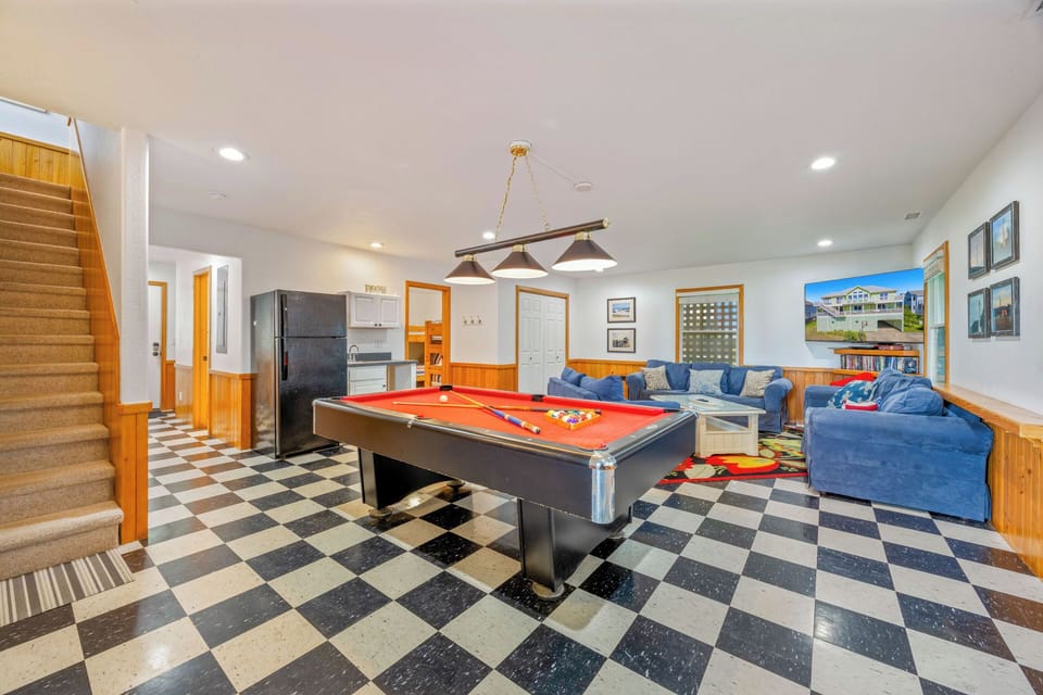 Step into your own vibrant game room, featuring a sleek pool table, plush lounge seating, and retro checkerboard floors—your perfect spot to unwind, challenge friends, and make memories together.