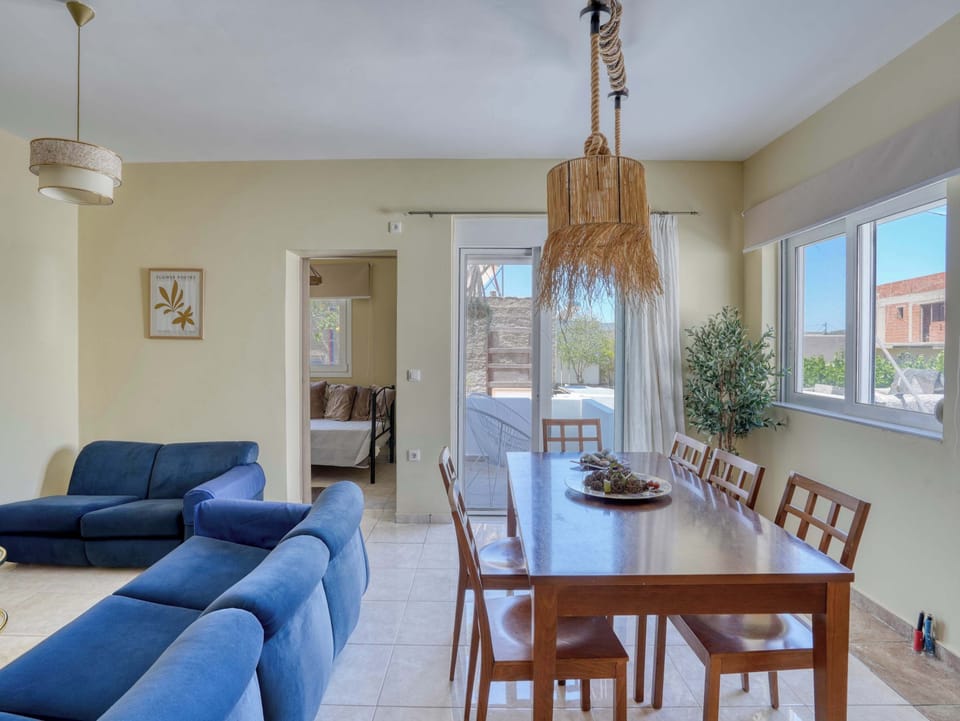 Large windows fill the living and dining area with natural light, creating an inviting setting throughout the day.