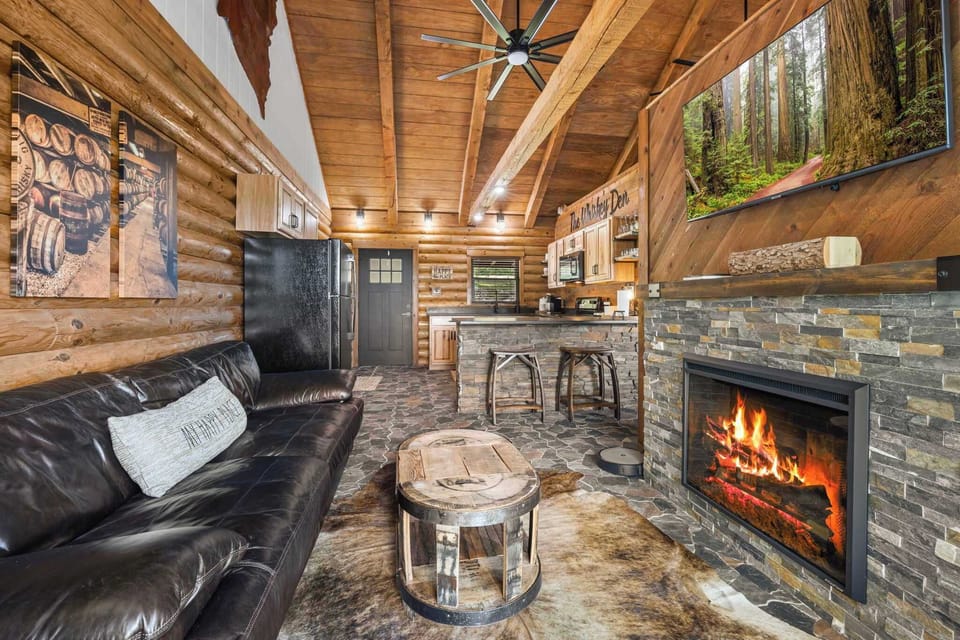 The living space has a couch, Smart TV, electric fireplace, and a fully stocked kitchen.