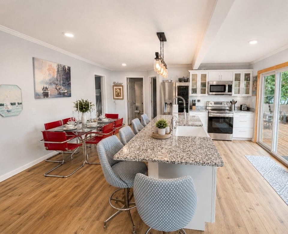 Spacious open-concept kitchen and dining area with oversized island seating, granite countertops, and room for the whole family.