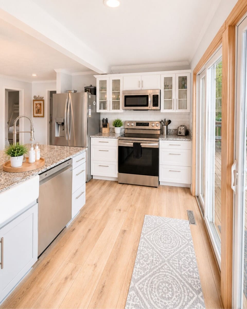 Chef-friendly kitchen with stainless steel appliances, generous counter space, and deck access for outdoor dining.