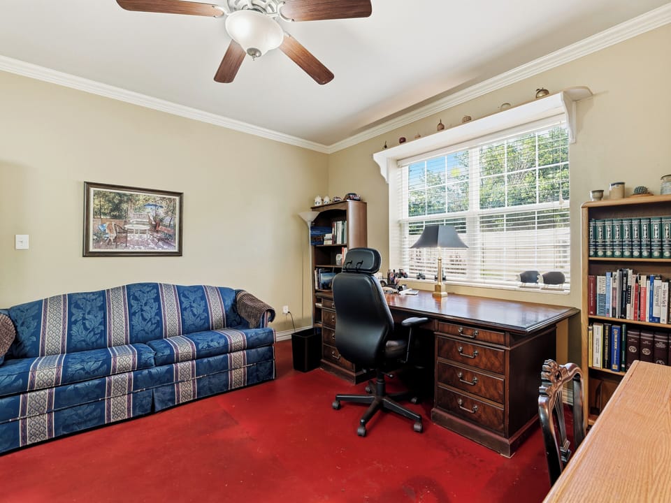 Settle into your private home office, where natural light streams through large windows and a ceiling fan keeps you comfortable while you work or plan your adventures.