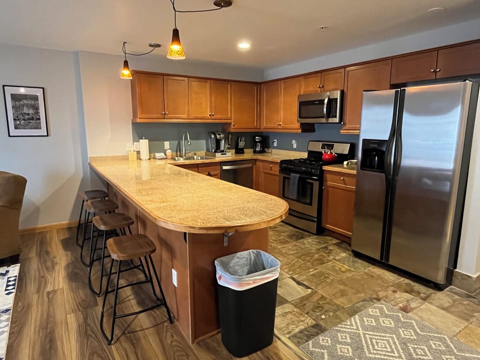 Your fully equipped kitchen features stainless steel appliances, granite countertops, and a breakfast bar—perfect for preparing home-cooked meals and gathering with loved ones.