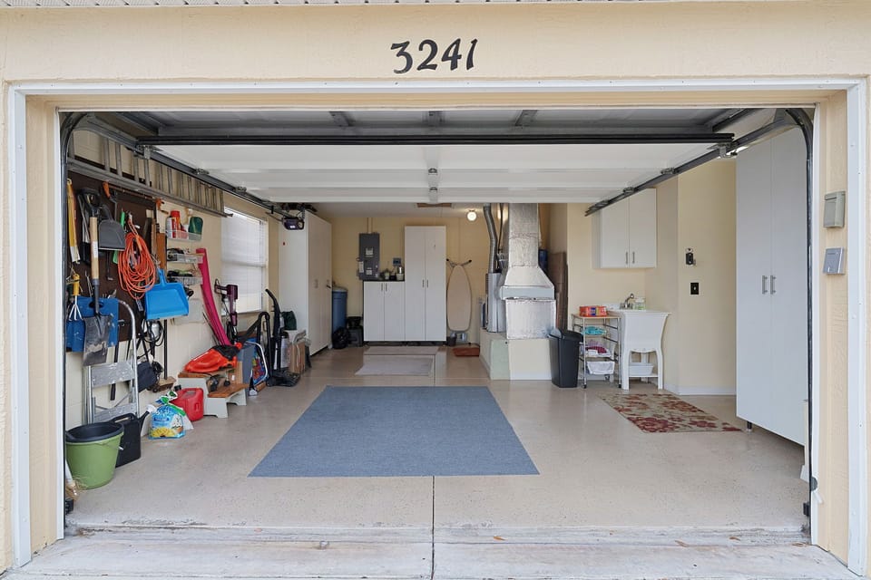 Property #3241: A well-organized garage with storage solutions, workspace, and convenient parking access for your arrival and stay.