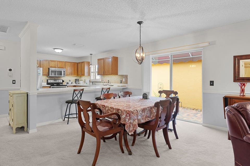 Gather around this inviting dining space that flows seamlessly into the fully-equipped kitchen, where you'll find everything needed to prepare and share memorable meals with your travel companions.