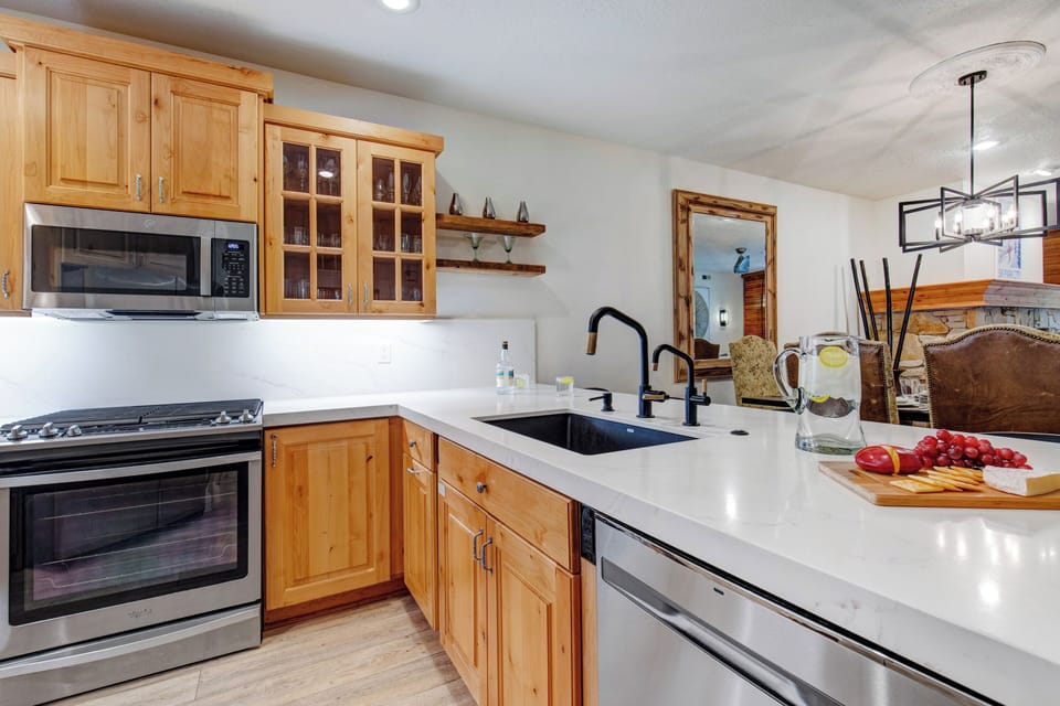Your dream vacation kitchen awaits with gleaming quartz countertops and breakfast bar.