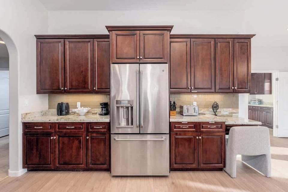 Step into your beautiful kitchen with rich cherry cabinetry, granite counters, and stainless appliances—ready for your culinary adventures and morning coffee rituals.