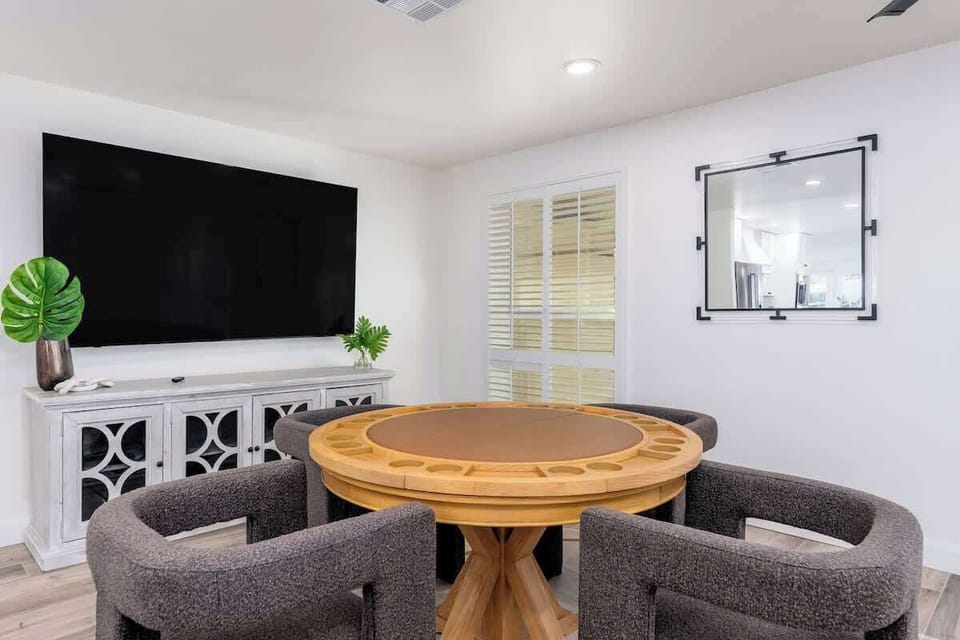 Gather around the custom game table for cards or conversation, with a large TV for movie nights and stylish seating that keeps everyone cozy and connected.