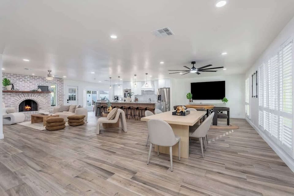 Unwind in your spacious open-concept haven, where rustic brick fireplace charm meets modern comfort. Gather at the dining table, relax by the cozy fire, or enjoy entertainment in this beautifully designed space.