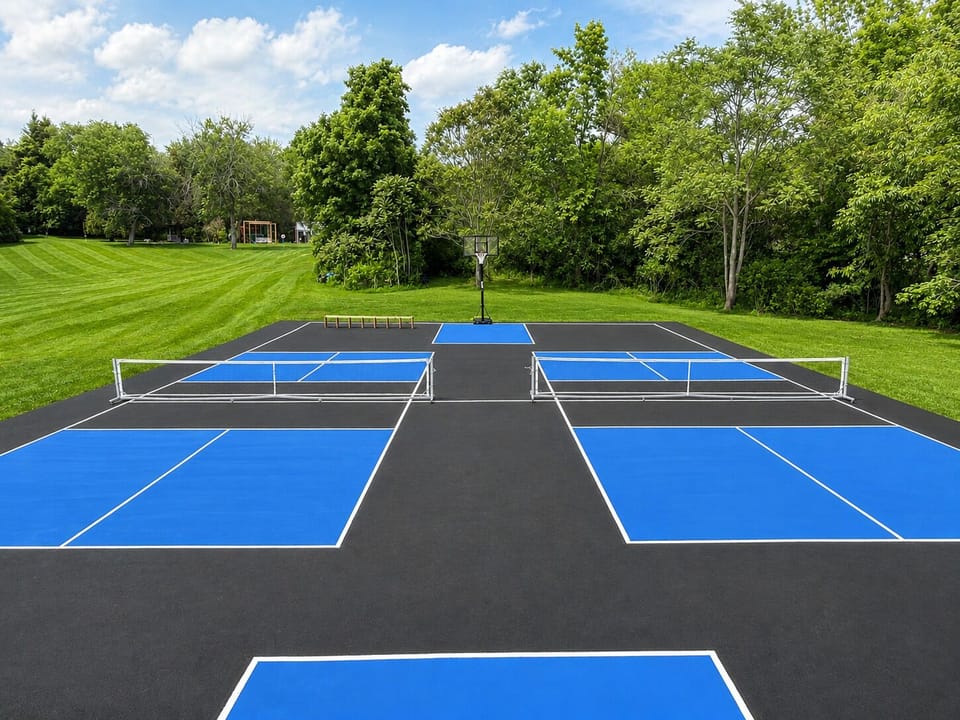 Two regulation size pickleball courts on a full NBA size basketball court