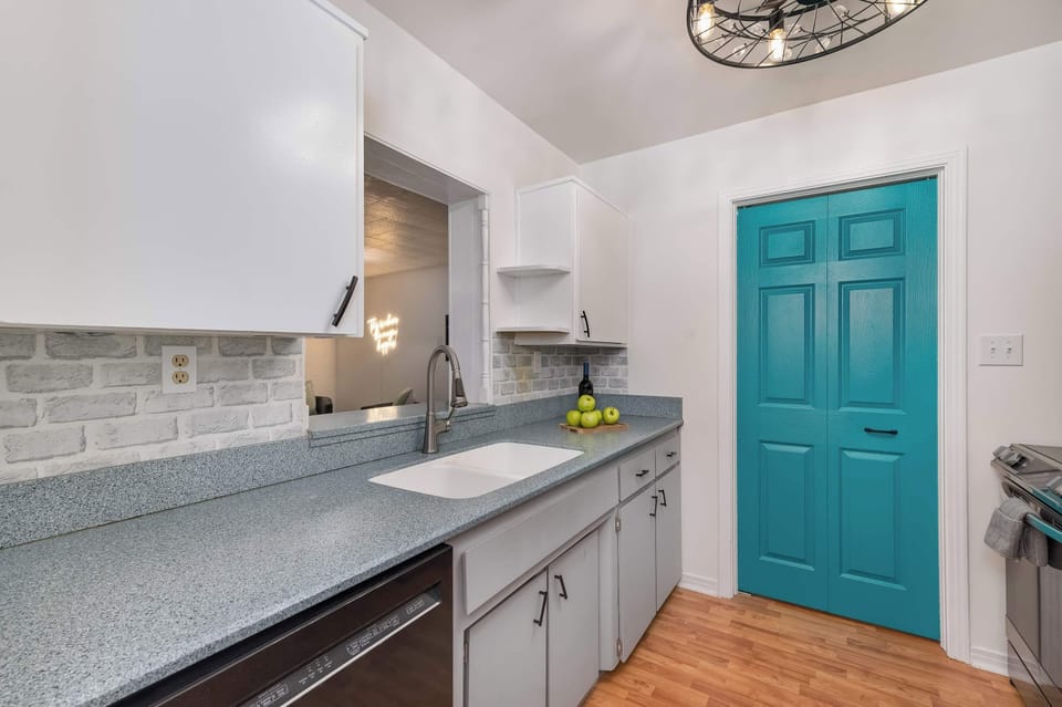 Well-equipped kitchen w/ teal cabinetry accents & generous prep space for group cooking.

