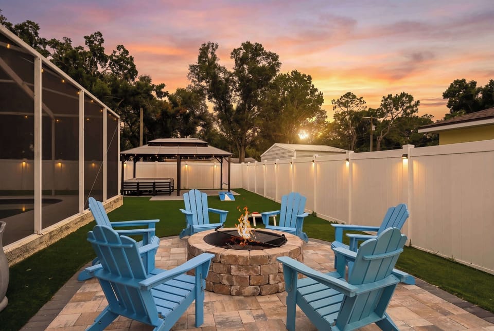 Unwind poolside at sunset w/ blue lounge chairs & warm Florida skies overhead.
