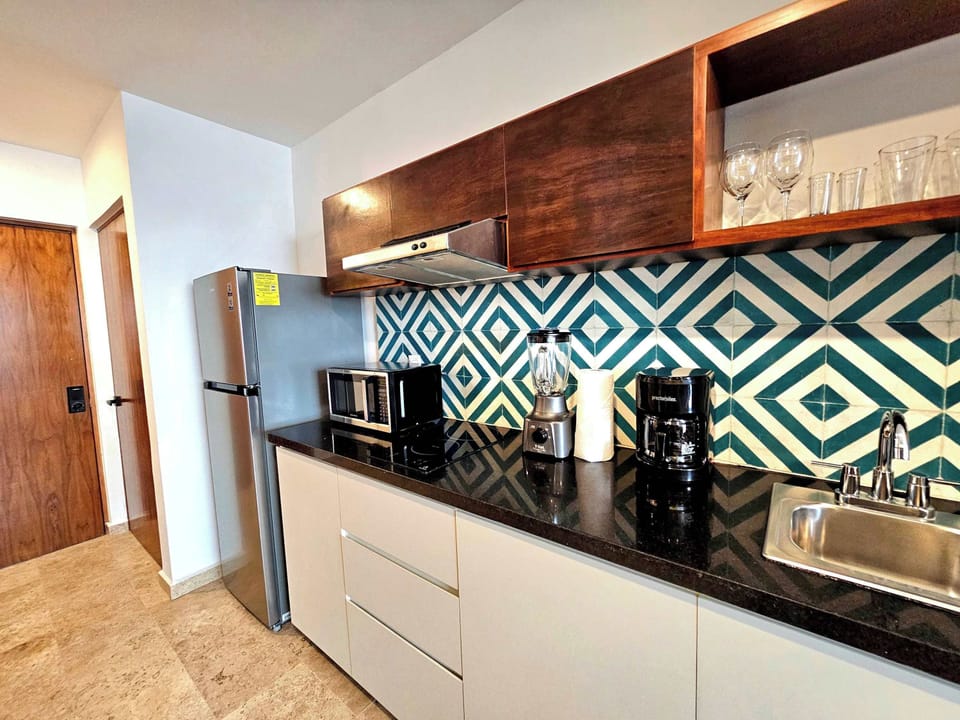 Fully equipped kitchen with stove, microwave, blender, toaster, and cookware