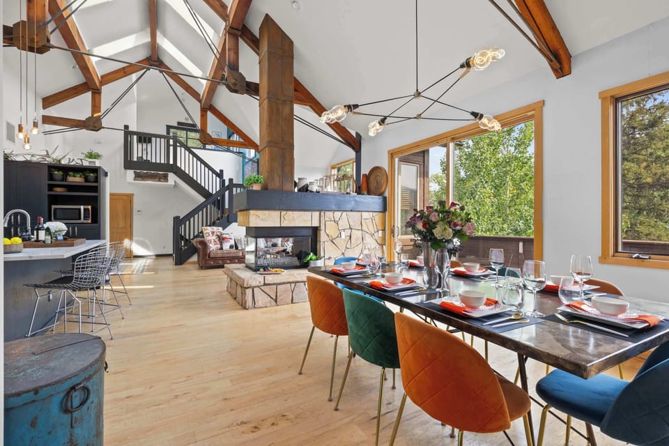 Dining area: Dual-sided fireplace, 8-person dining table, 3 barstools at the island kitchen bar
