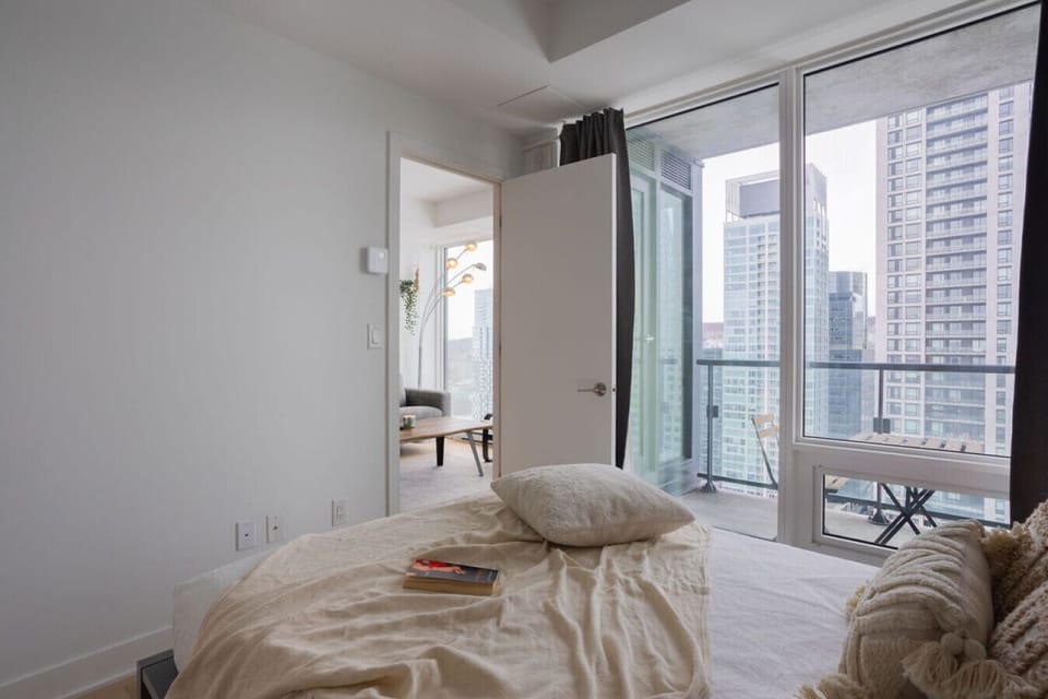 Indulge in panoramic city views from expansive windows, creating a calm and airy retreat