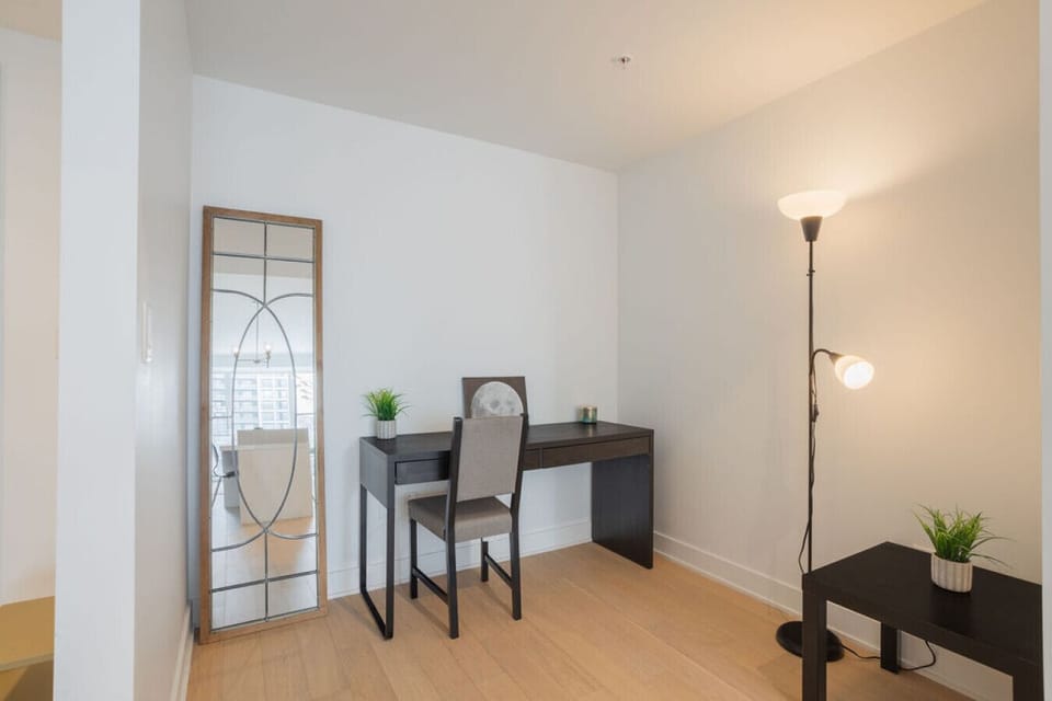 Discover a quiet nook for work or reflection, complete with a stylish desk and warm lighting