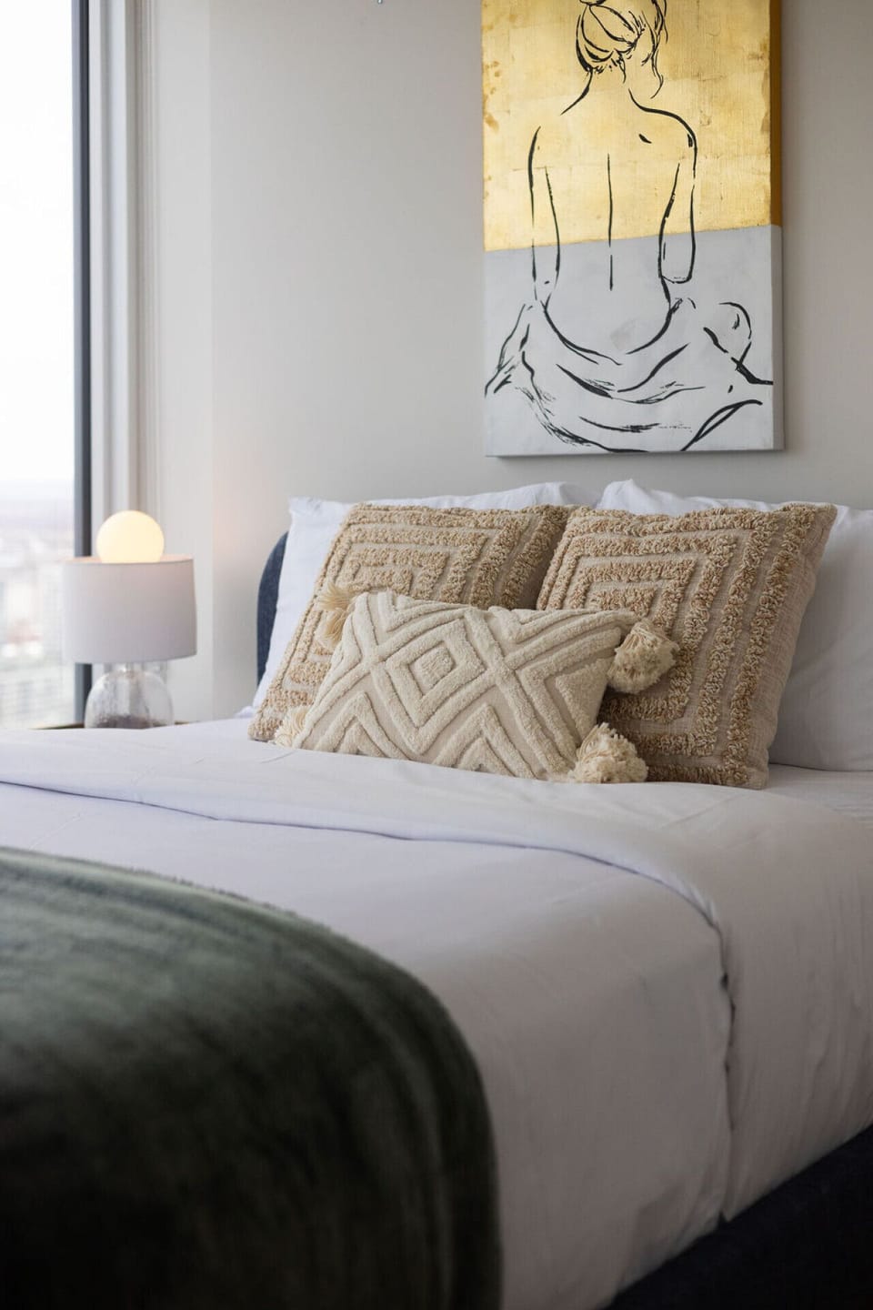 Soak in the cozy ambiance, highlighted by statement art and plush bedding