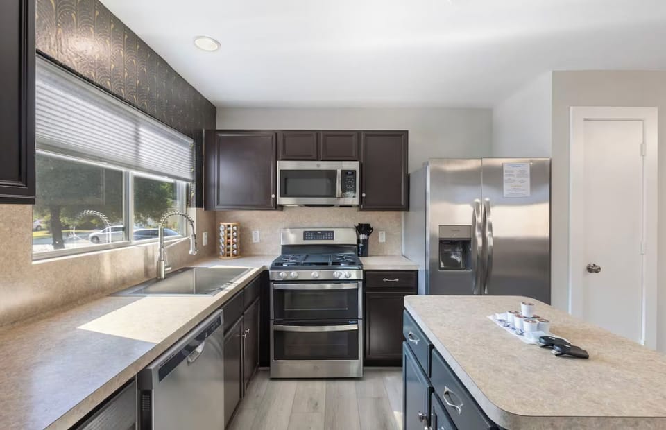 Enjoy the natural light that comes through the window to the large stainless ste