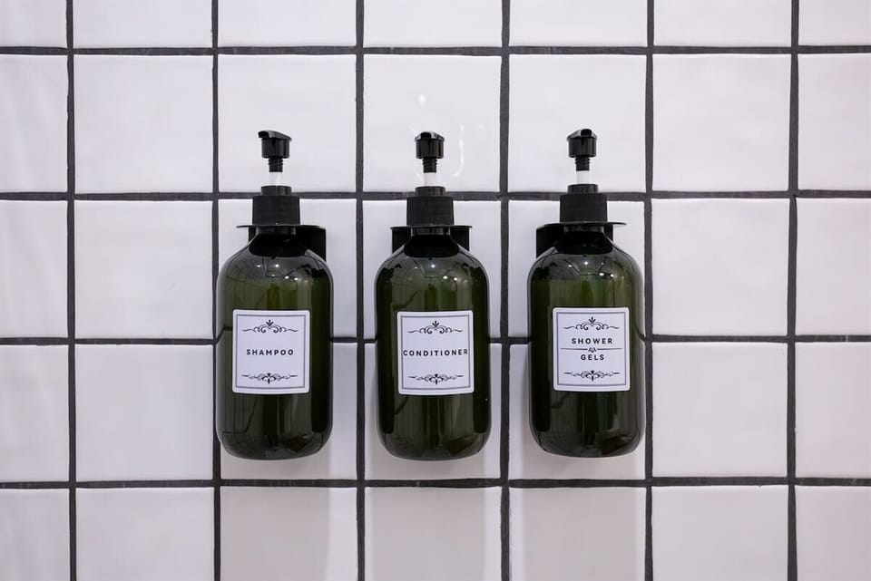 This fully stocked bathroom features shampoo, conditioner, body wash, and even a hairdryer for ultimate convenience and comfort.