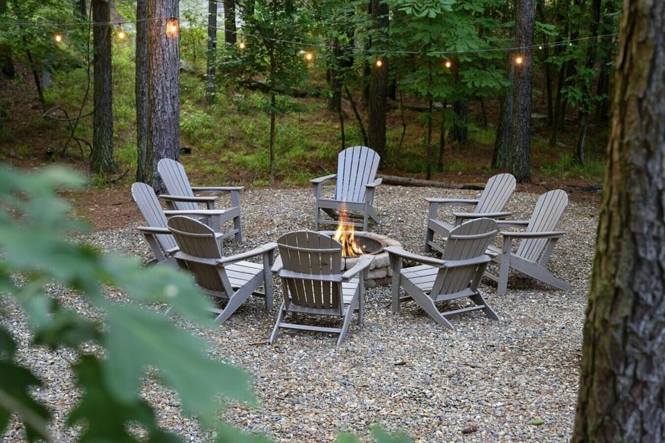 Eight chairs around the fire mean there`s always room for the whole group under the pines.