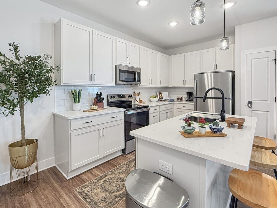 Fully stocked kitchen with stainless steel appliances, cookware, bakeware, blender, and rice cooker—perfect for preparing meals during your stay.