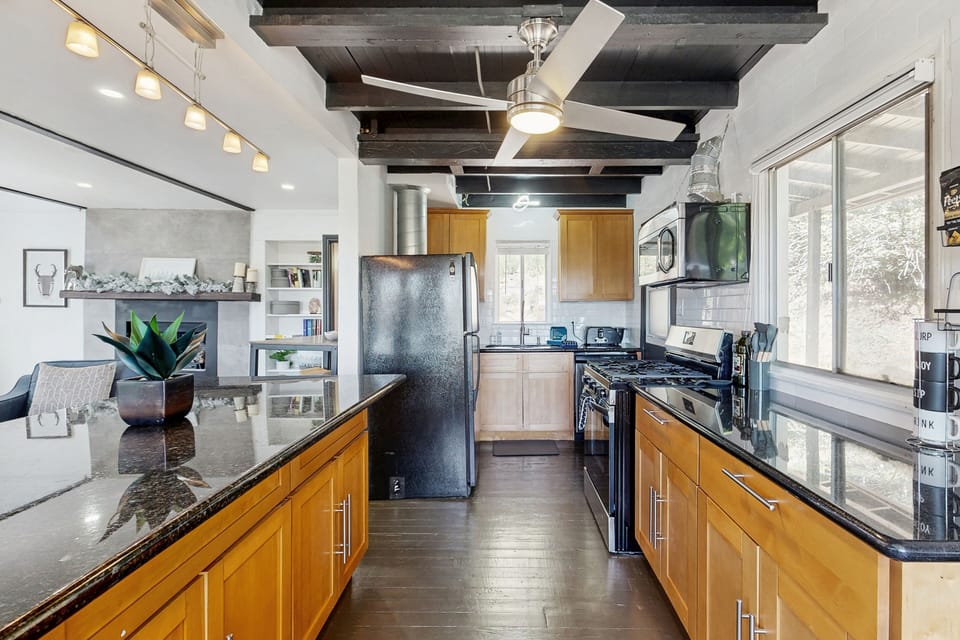 Equipped with stainless steel appliances, spacious island, and cooking essentials.