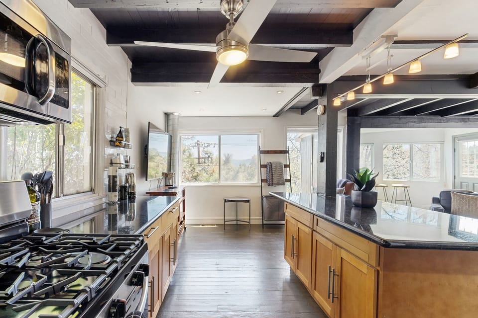 Equipped with stainless steel appliances, spacious island, and cooking essentials.