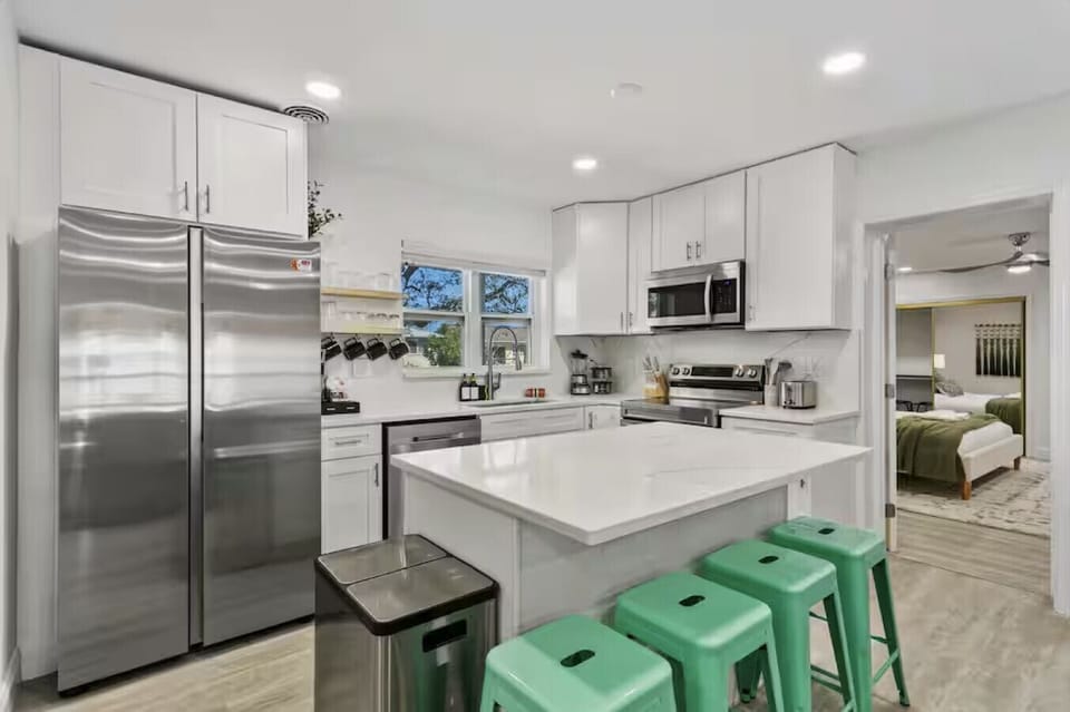 A chef-friendly kitchen with a big fridge and island made for sharing meals