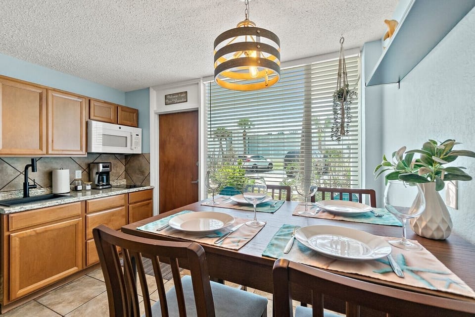 Dining space and kitchenette with a view toward the ground-level porch.