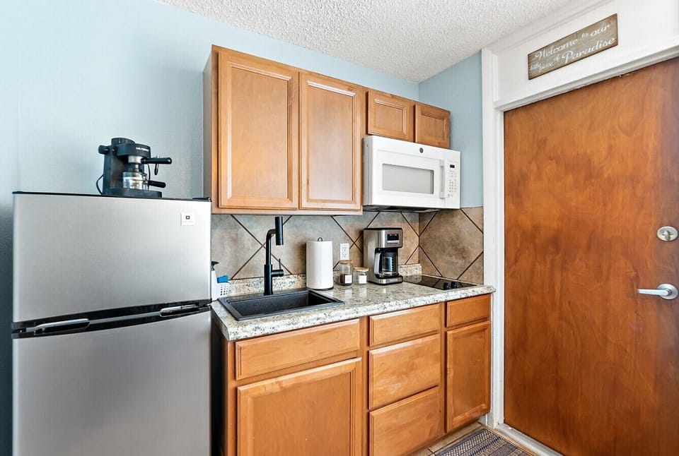Kitchenette with the basics for coffee, snacks, leftovers, and light meals.