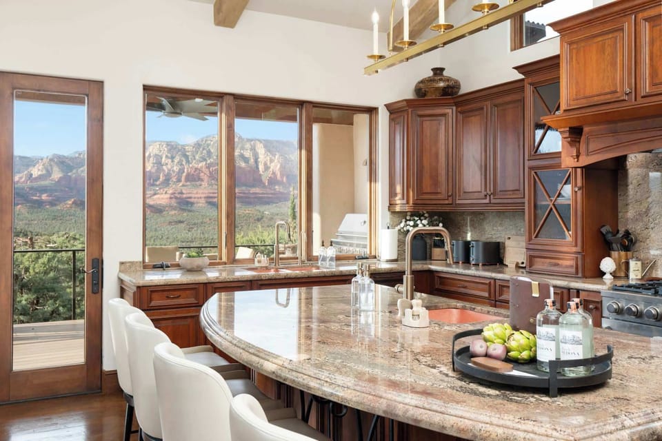 Whether you're preparing a family meal or enjoying a morning coffee, the spacious kitchen island offers front-row views of Sedona's iconic red rocks.