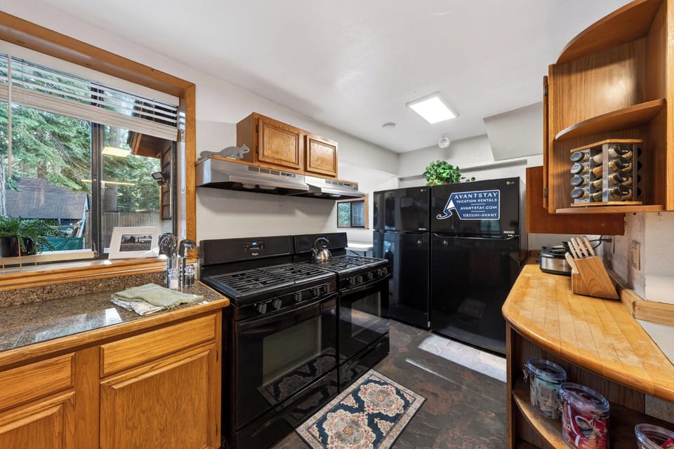Professional-grade cooking zone with two large range ovens and two refrigerators.