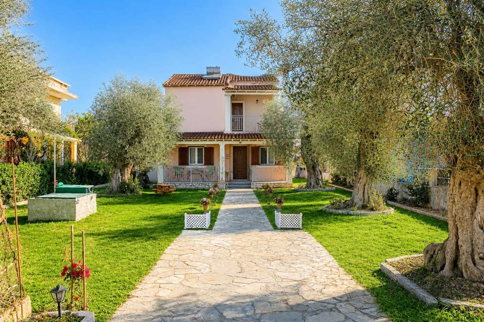 A charming pathway lined with olive trees that leads through the property, creating a peaceful and authentic Mediterranean setting