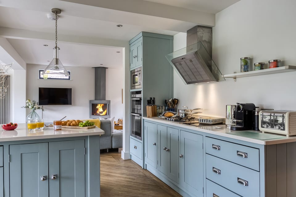 Stylish and practical, this contemporary kitchen flows seamlessly into the inviting sitting area