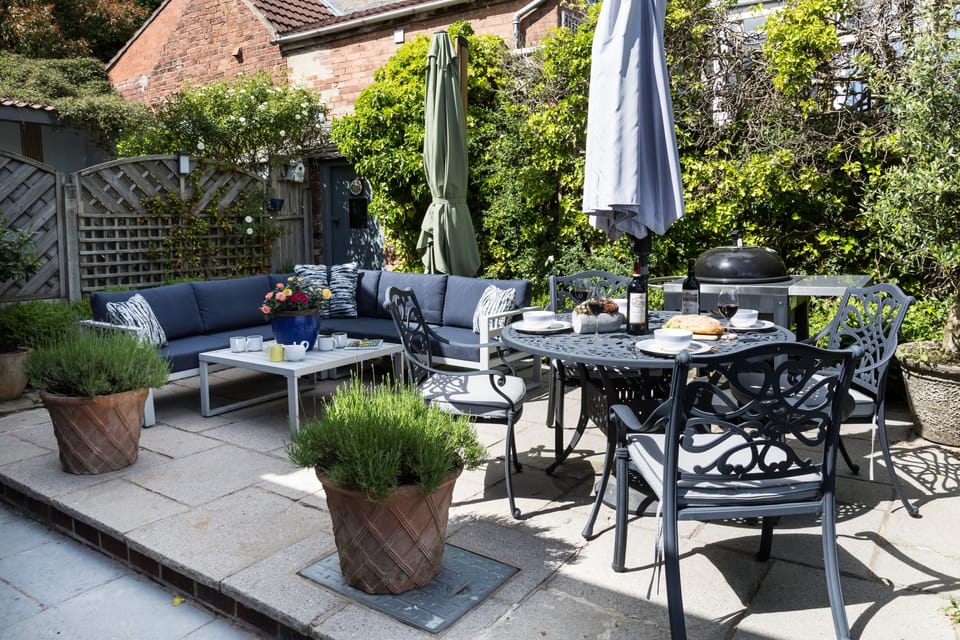 An exceptional courtyard setting, where contemporary comfort meets cottage garden charm, offering a tranquil place to unwind in style.