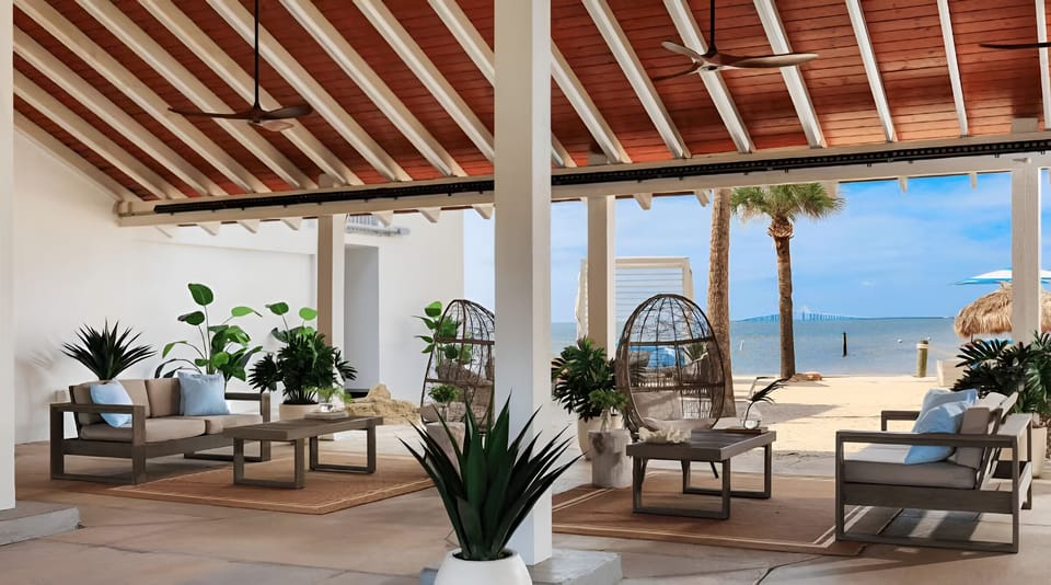 Unwind under shaded seating with sweeping beachfront views.