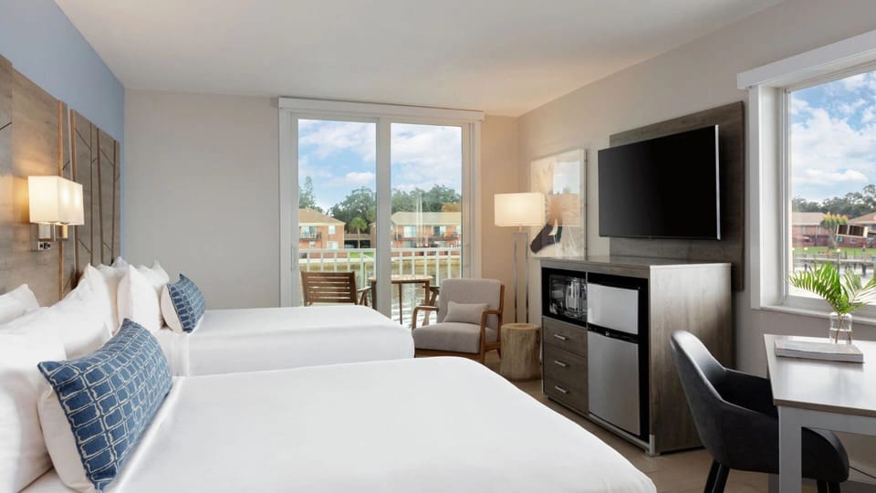 Unwind in a bright room with balcony breezes and seating.