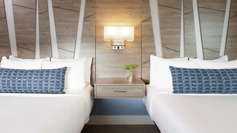 Sink into soft pillows beneath striking modern wood accents.