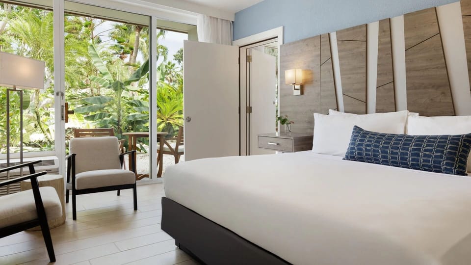 Unwind in crisp linens with lush patio views.