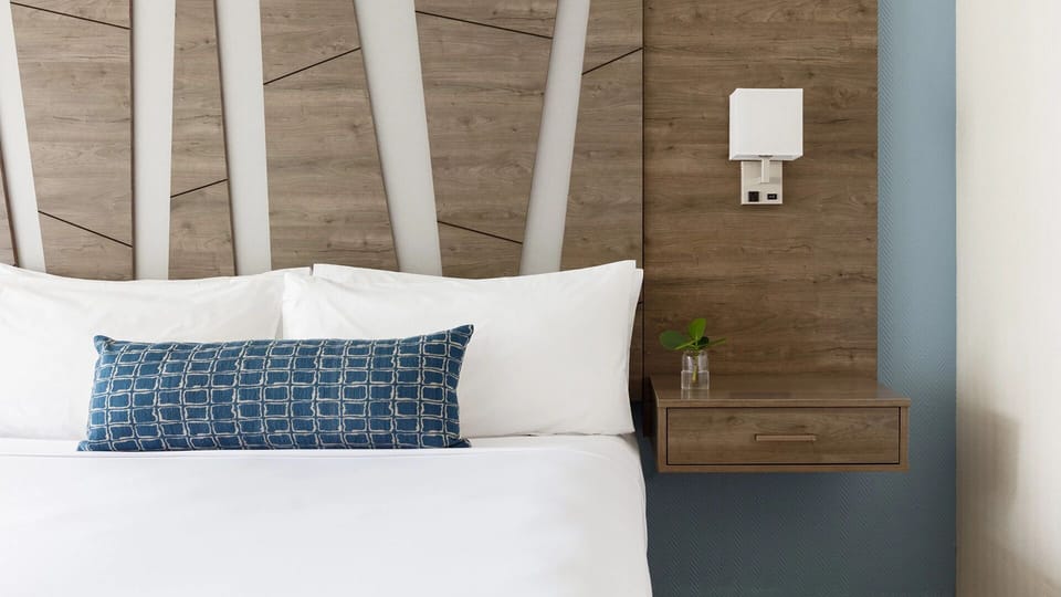 Drift off surrounded by warm wood accents and soft pillows.